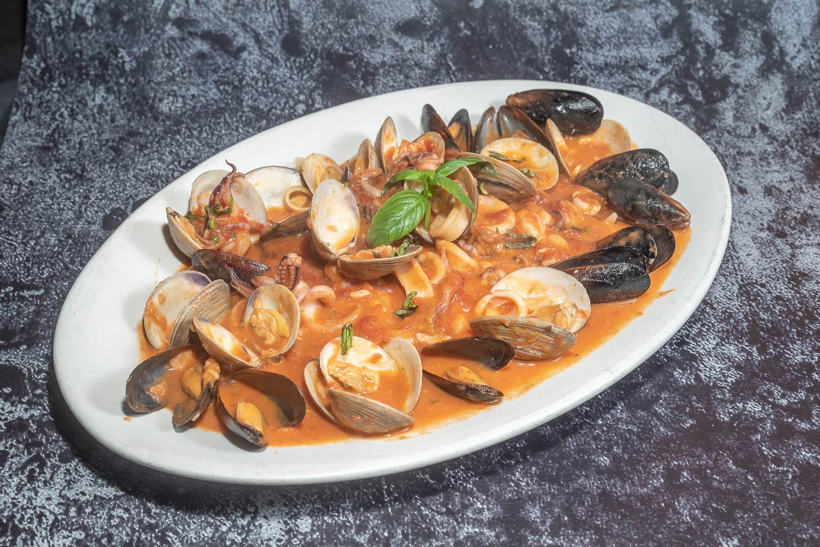 Seafood pasta with clams, mussels, and calamari in tomato sauce