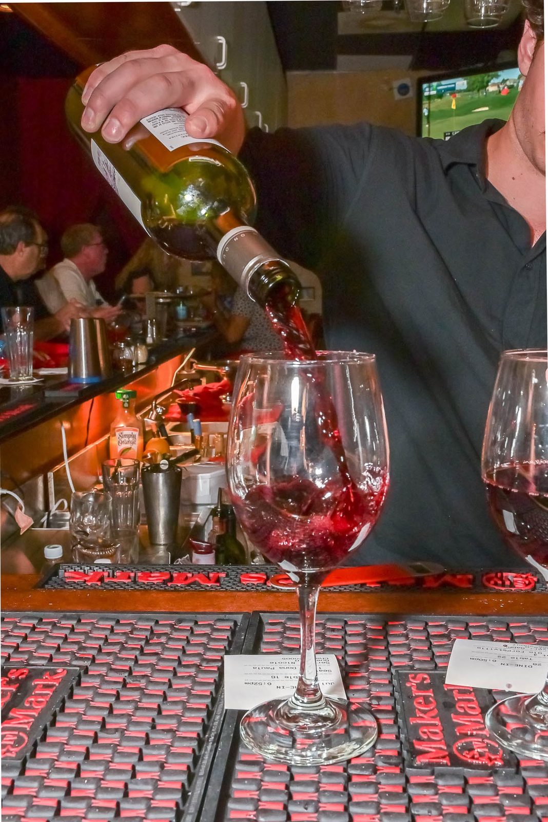 A glass of red wine being poured at the SOLO bar